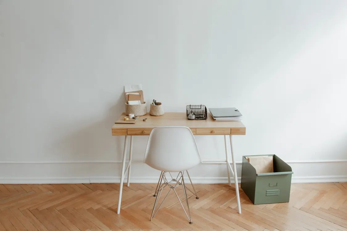 Minimalist wooden desk and chair — illustrative concept